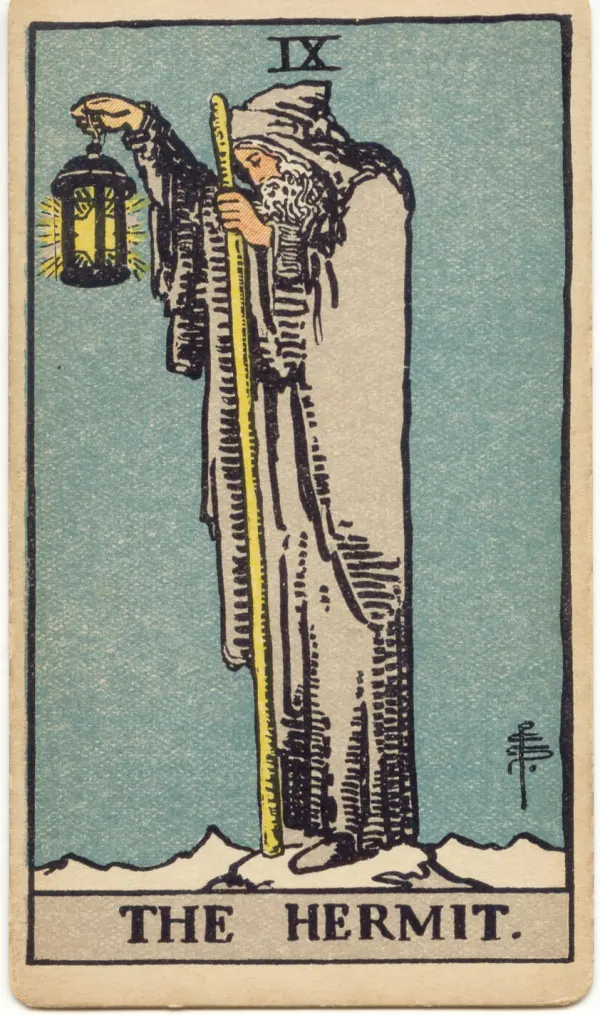 The Hermit: a cloaked figure on a snowy peak holding a lantern and a staff.